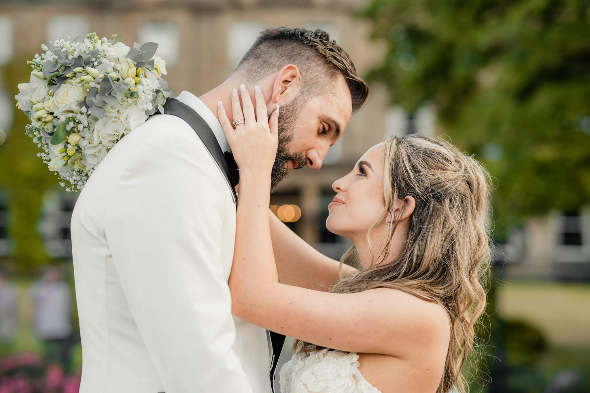 A romantic close-up of a bride and groom gazing into each other’s eyes, sharing an intimate and joyful moment on their wedding day.