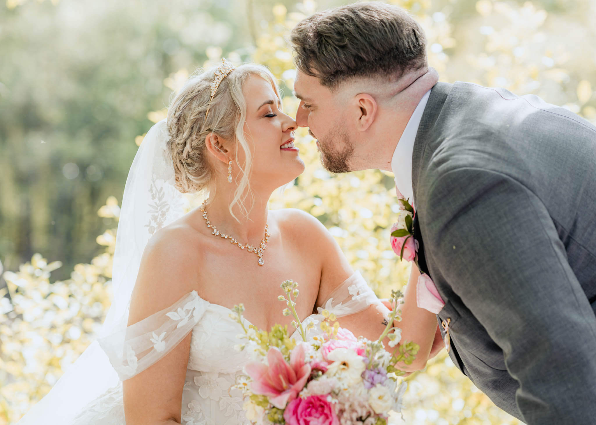 Bride and groom leaning in for a kiss at Chevin Country Park Hotel.