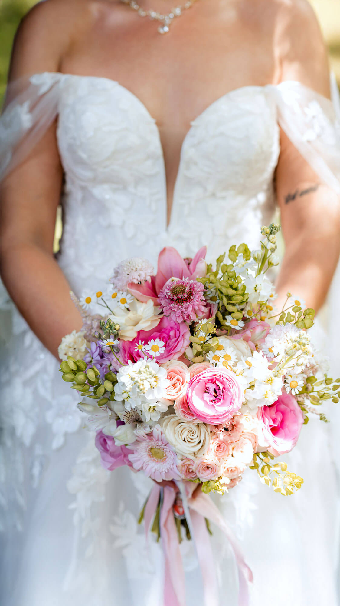 Editorial bridal portrait with colorful bouquet and lace wedding dress