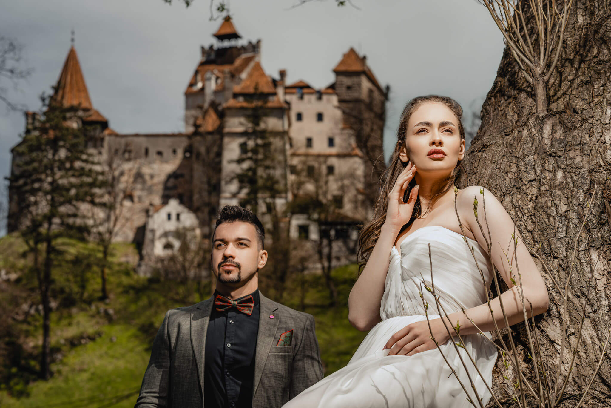 Modern bridal inspiration portrait with bride and groom near castle venue in natural light