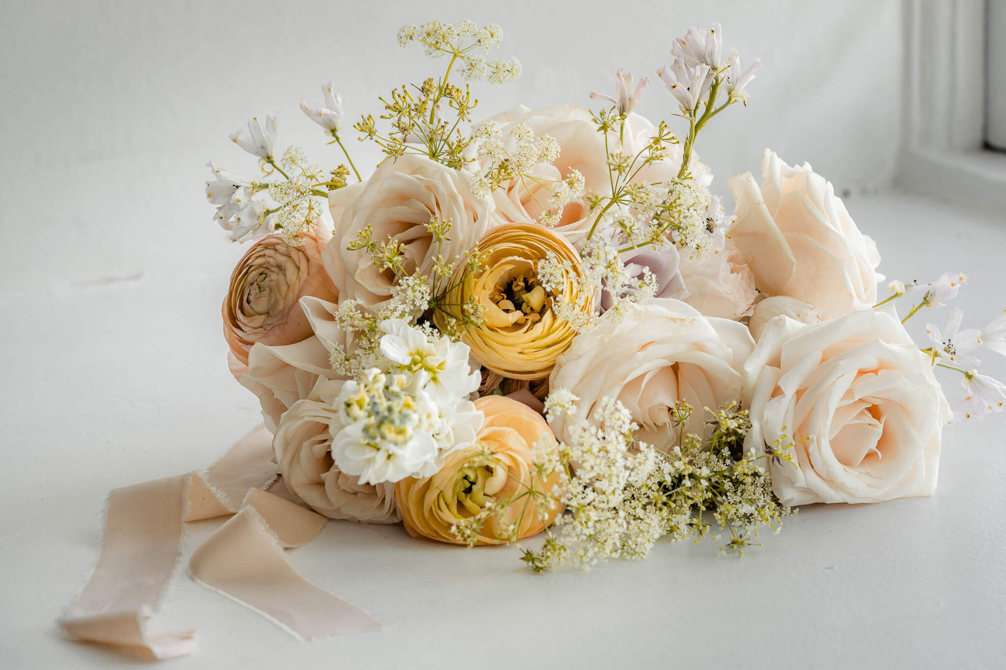 Soft pastel bridal bouquet arranged for editorial bridal portraits at Hazlewood Castle