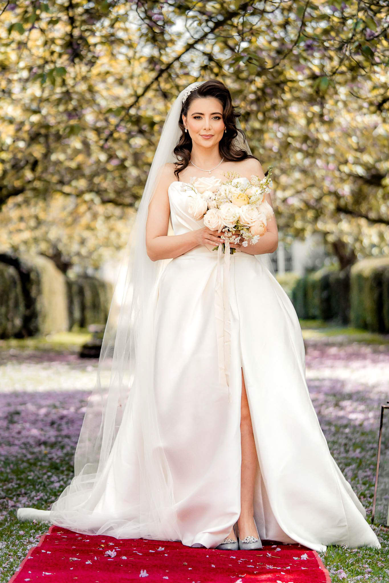 Bride holding bouquet during outdoor bridal portraits in the Hazlewood Castle gardens