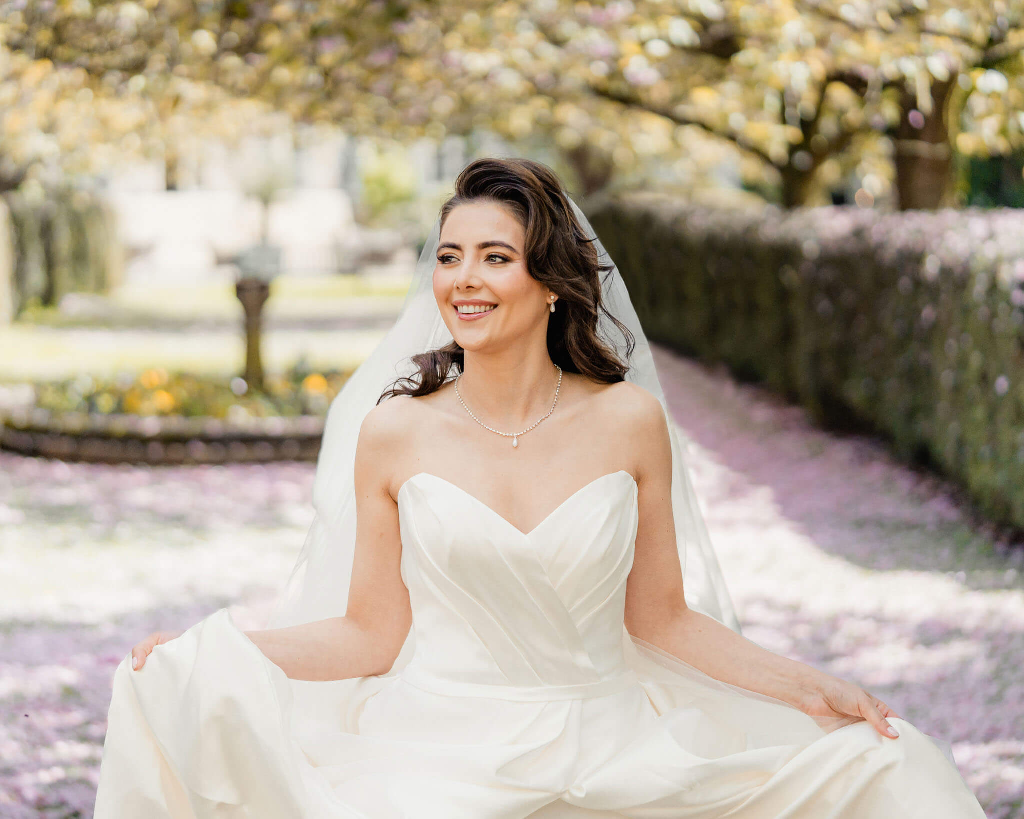 Bride smiling during outdoor bridal portraits in the Hazlewood Castle gardens