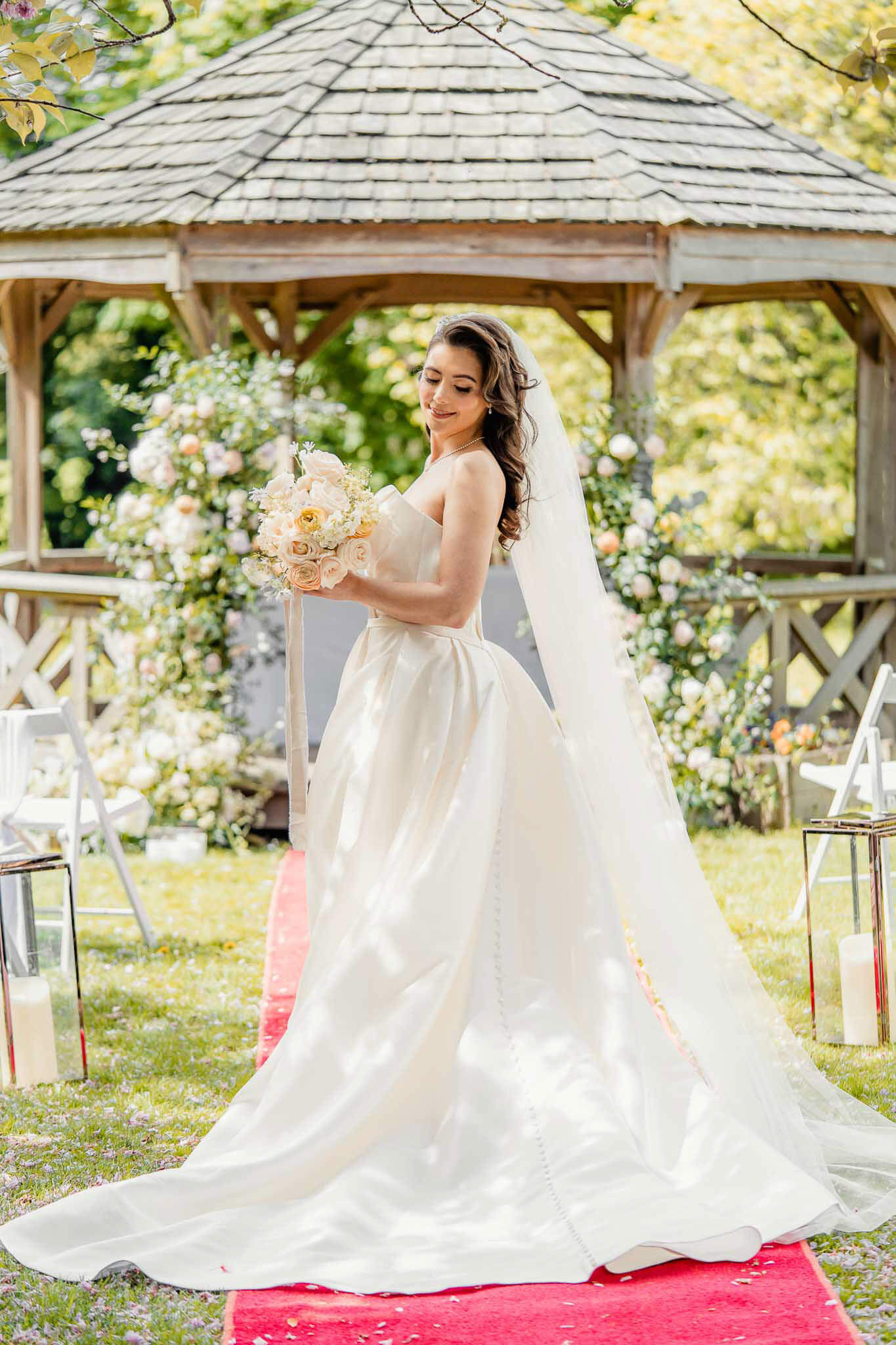 Bride posing near a gazebo during editorial bridal portraits at Hazlewood Castle