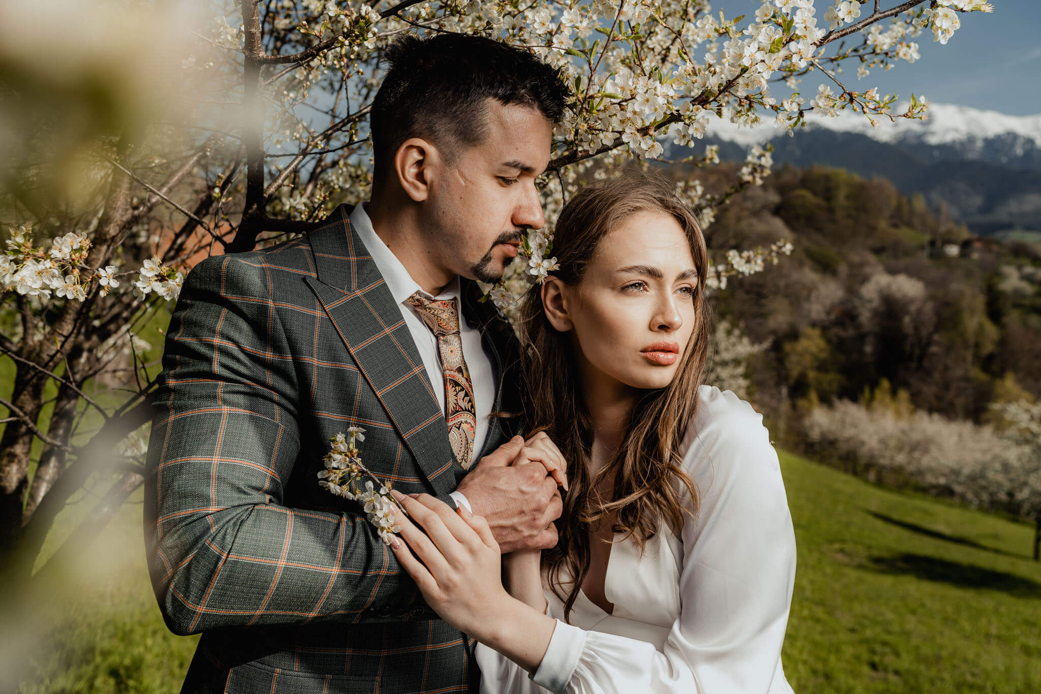 editorial couple portrait with blossom trees and natural light