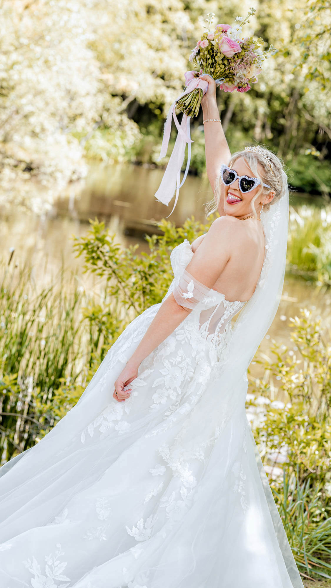 Modern bridal portrait outdoors with bride holding bouquet and wearing sunglasses