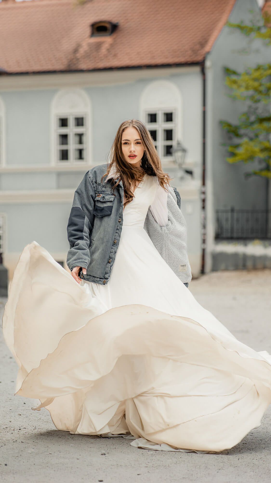 Modern editorial bridal portrait with flowing wedding dress outdoors