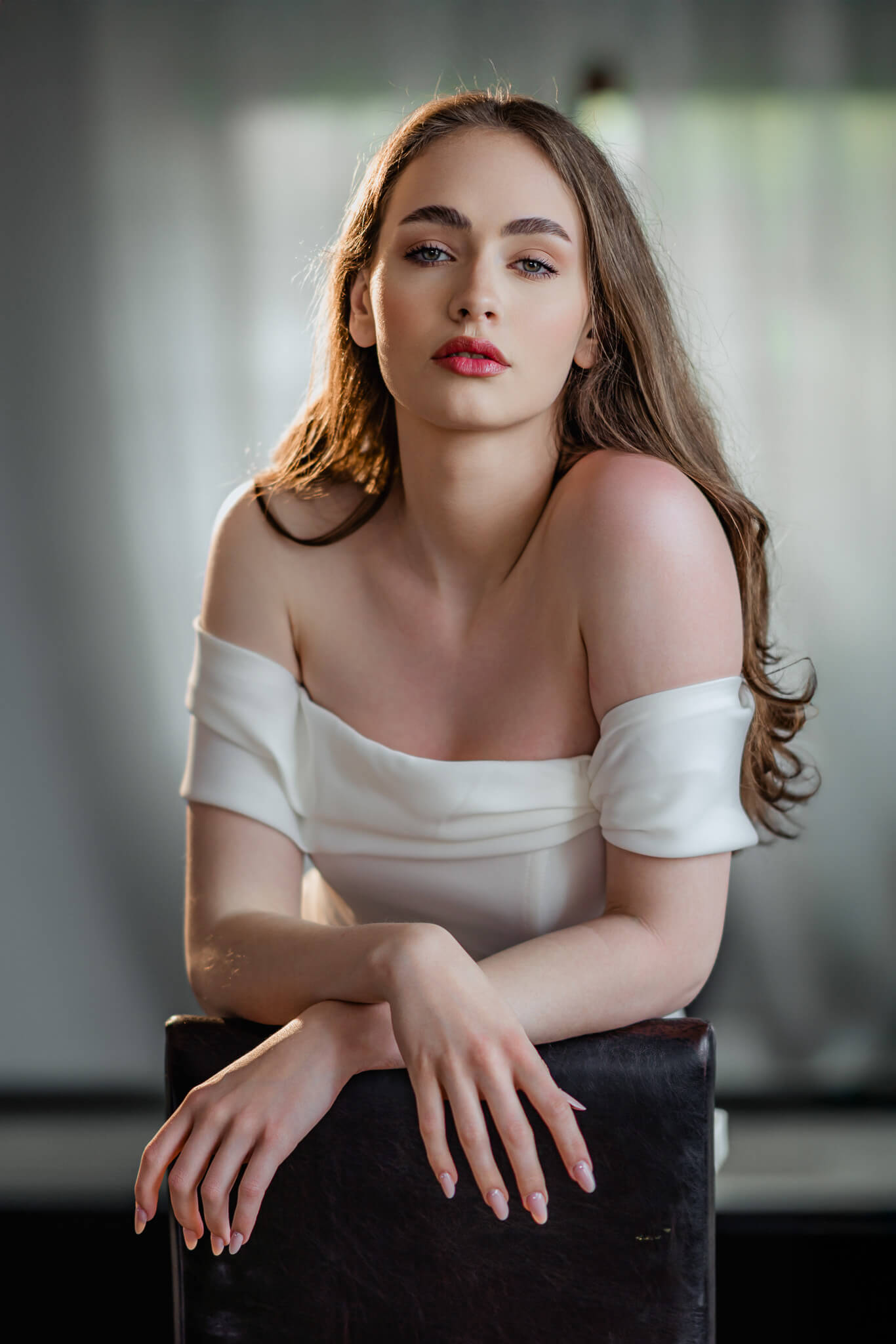 A refined editorial bridal portrait set against a dramatic castle backdrop, blending modern wedding styling with timeless European scenery.