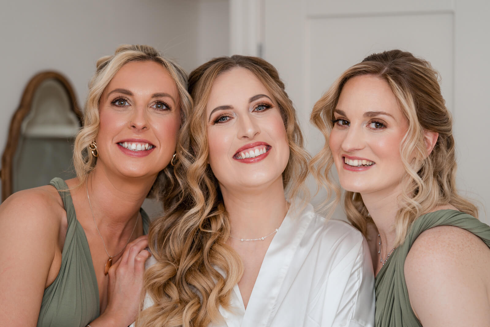 Bride smiling with bridesmaids during wedding morning preparations in Yorkshire