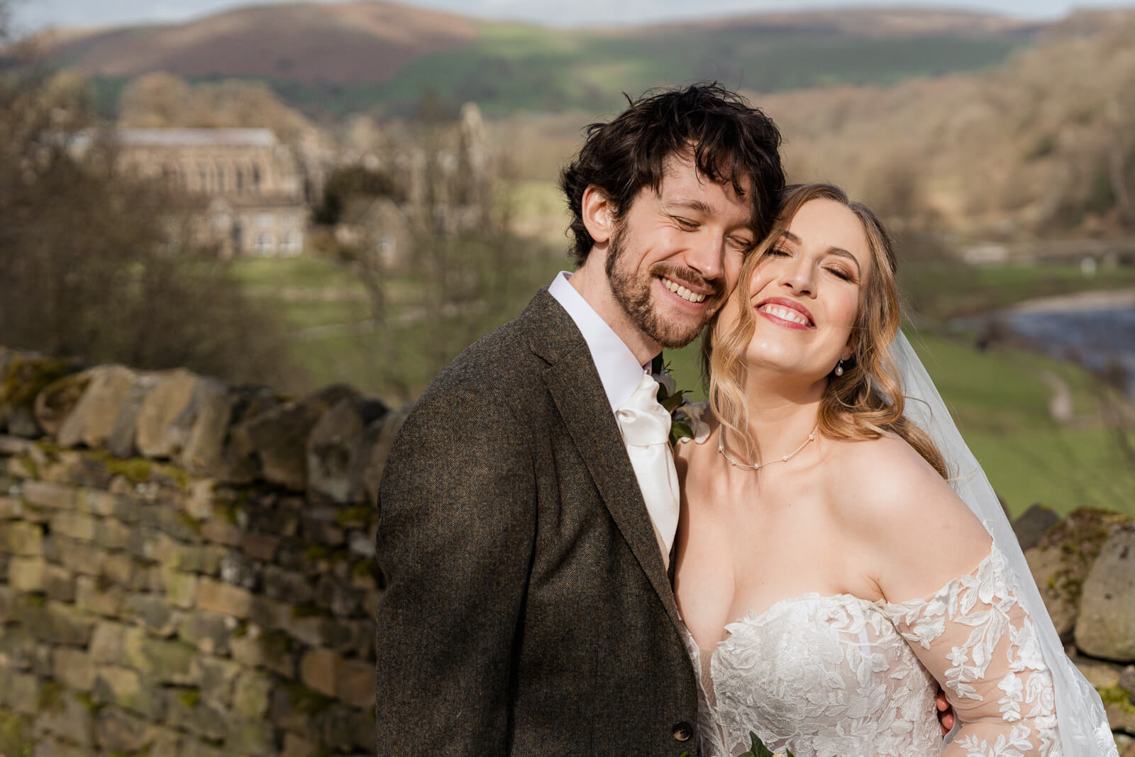 Bride and groom portrait at The Tithe Barn at Bolton Abbey with Yorkshire countryside views