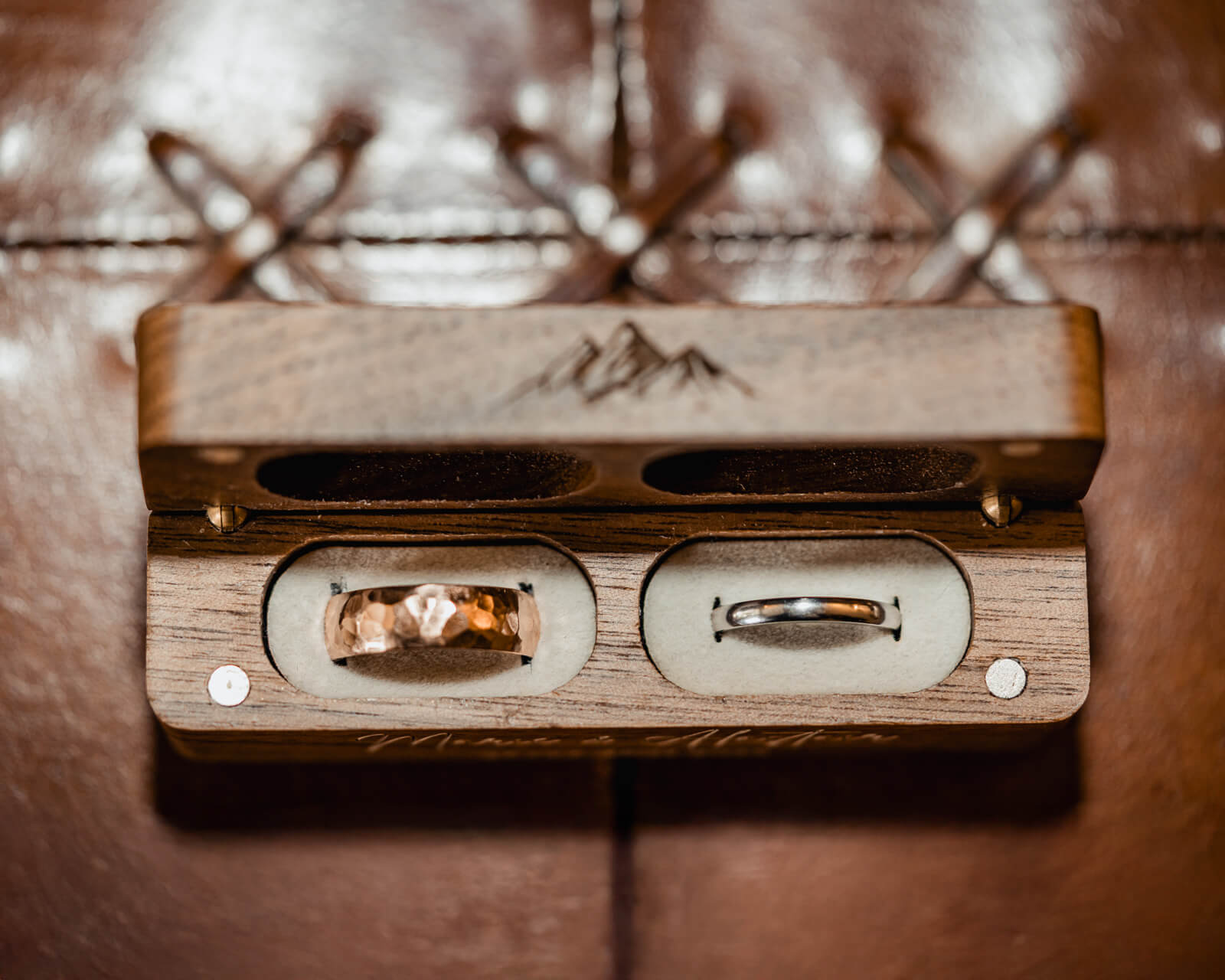 Wedding rings in wooden ring box detail at The Tithe Barn at Bolton Abbey