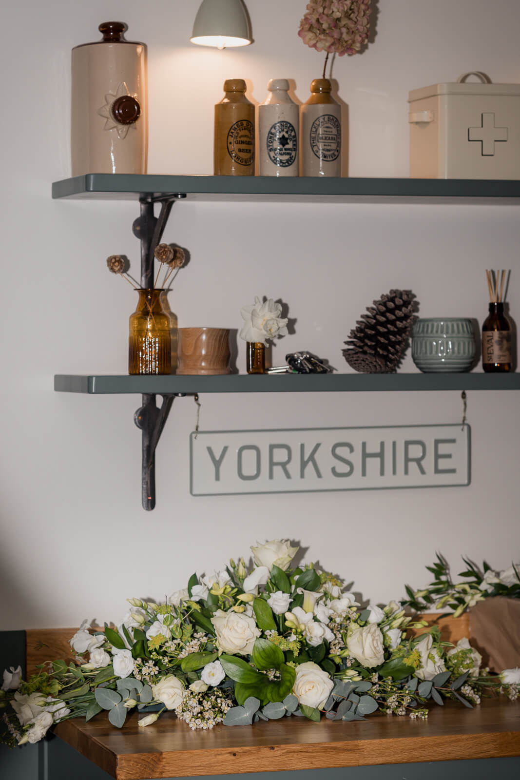 Wedding floral arrangement and Yorkshire decor details inside The Tithe Barn at Bolton Abbey