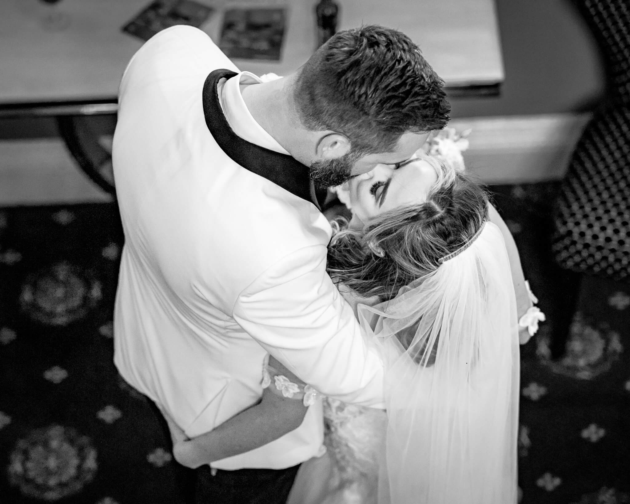 Overhead view of bride and groom kissing during first dance