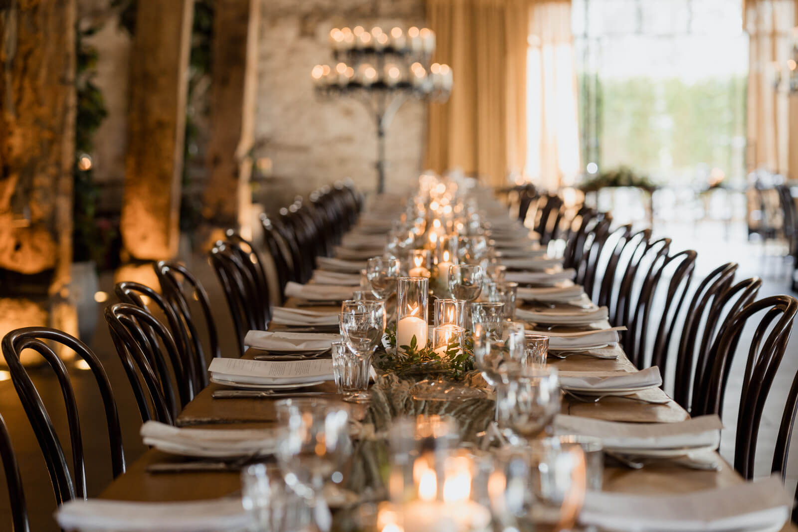 Elegant wedding reception table with candlelight and place settings