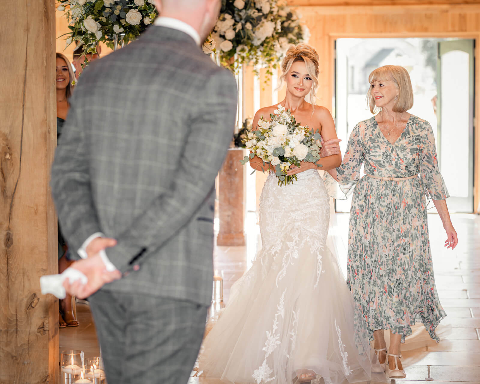 Bride walking down the aisle with her mother at Colshaw Hall Country Estate