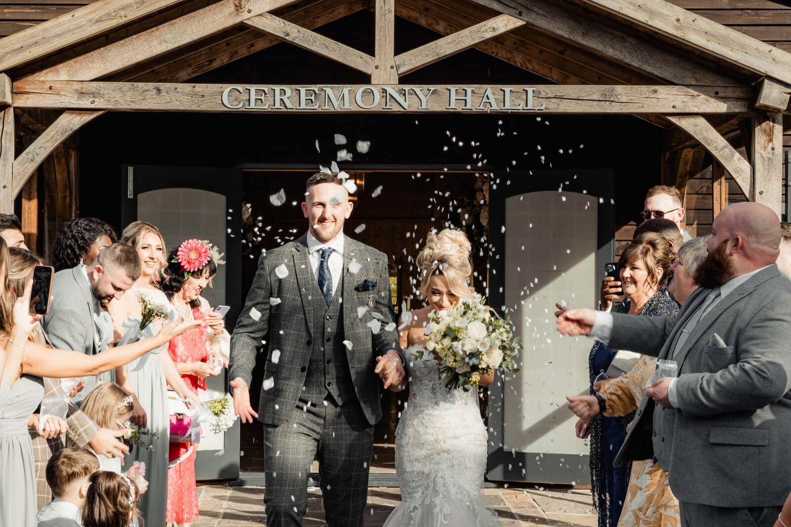 A soft and intimate portrait of the bride resting her head on the groom’s shoulder, captured in warm light with a calm and romantic atmosphere.