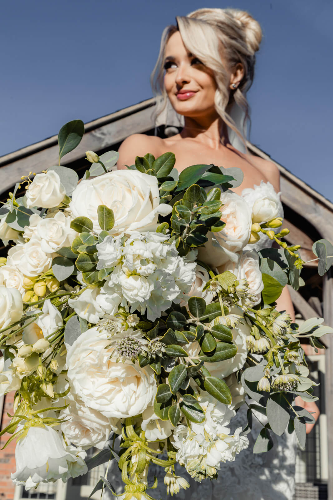 Bride holding lush white bouquet during Elegant Wedding at Colshaw Hall Country Estate
