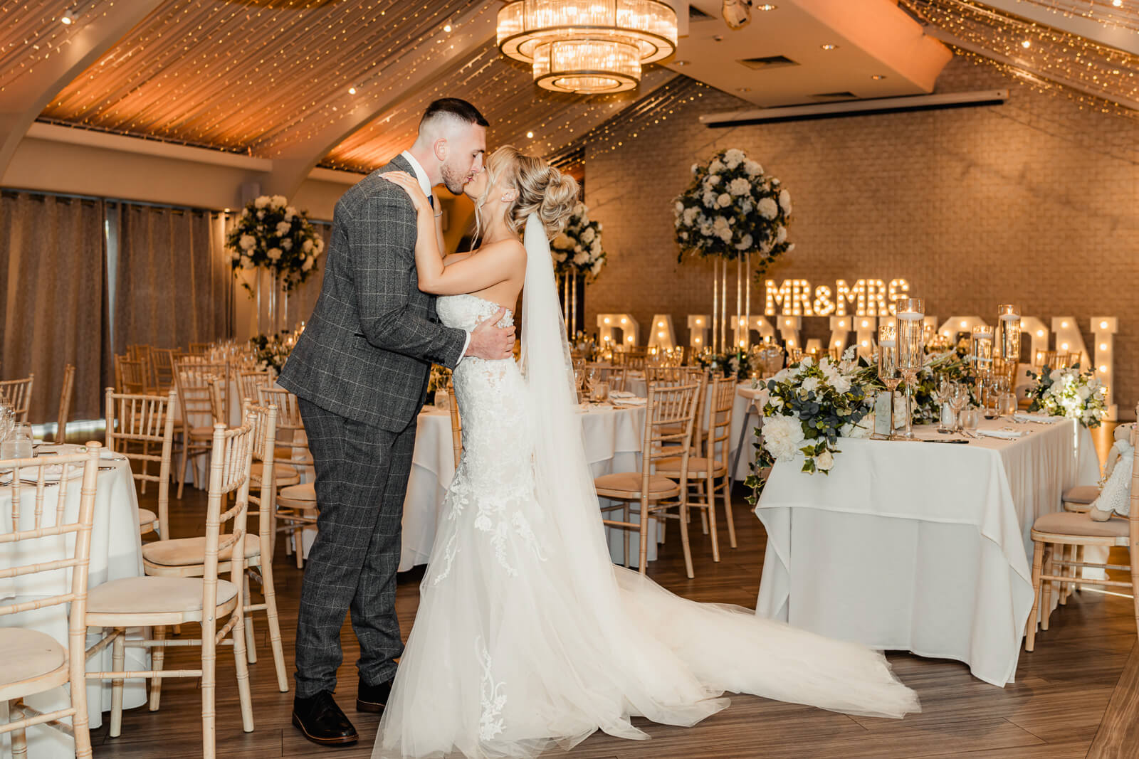 Bride and groom kissing in reception space during Elegant Wedding at Colshaw Hall Country Estate
