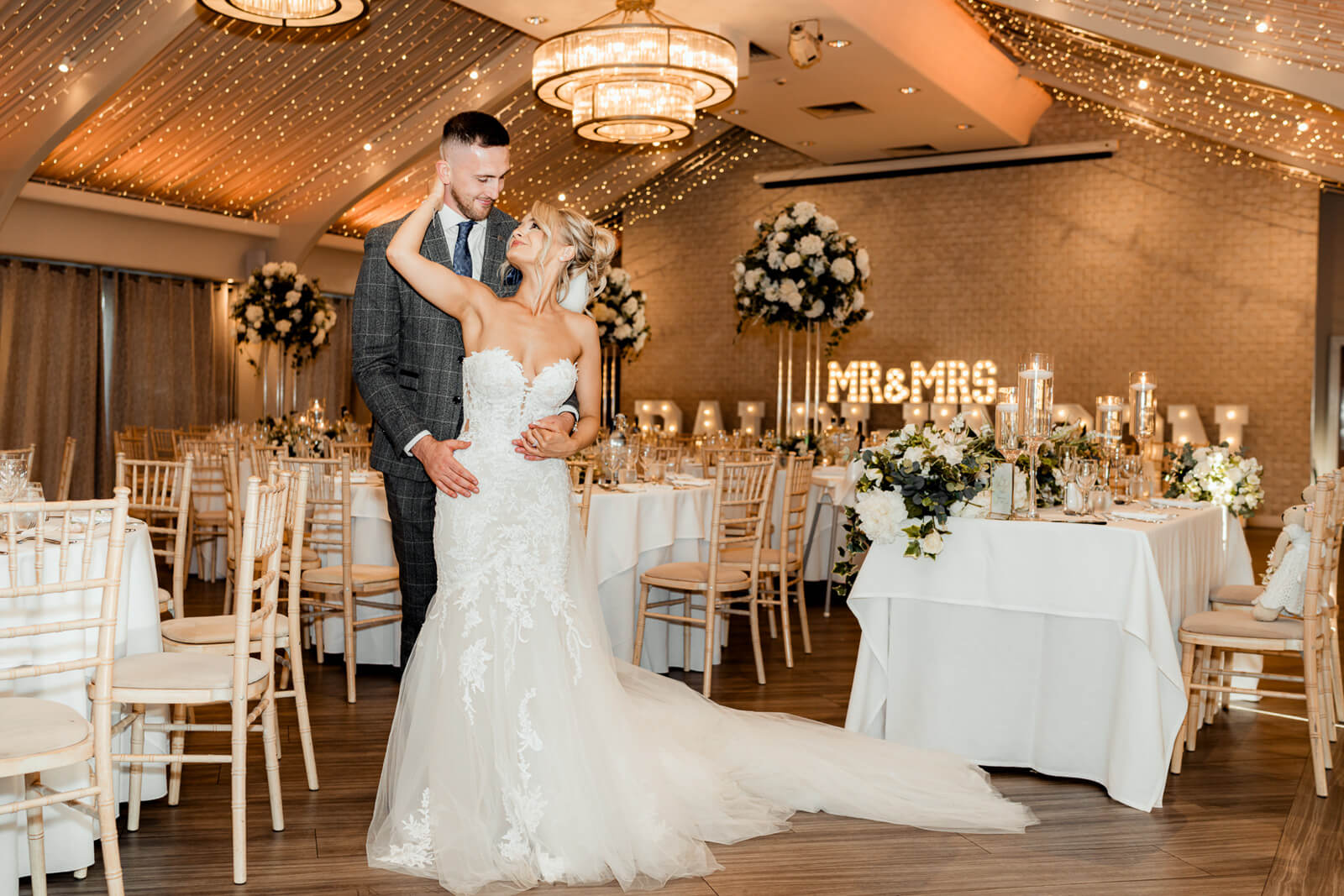 Bride and groom embracing in reception room during Elegant Wedding at Colshaw Hall Country Estate