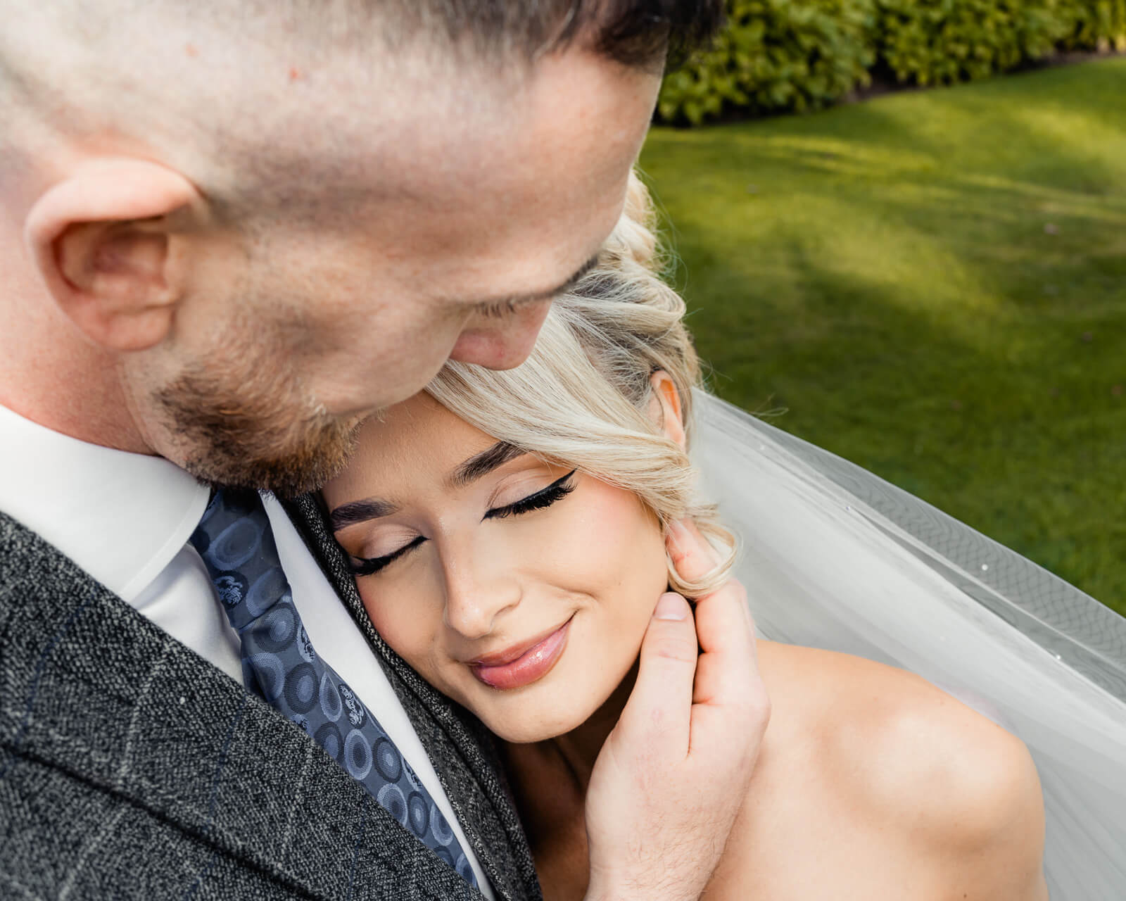 Close-up of bride and groom embracing during Elegant Wedding at Colshaw Hall Country Estate