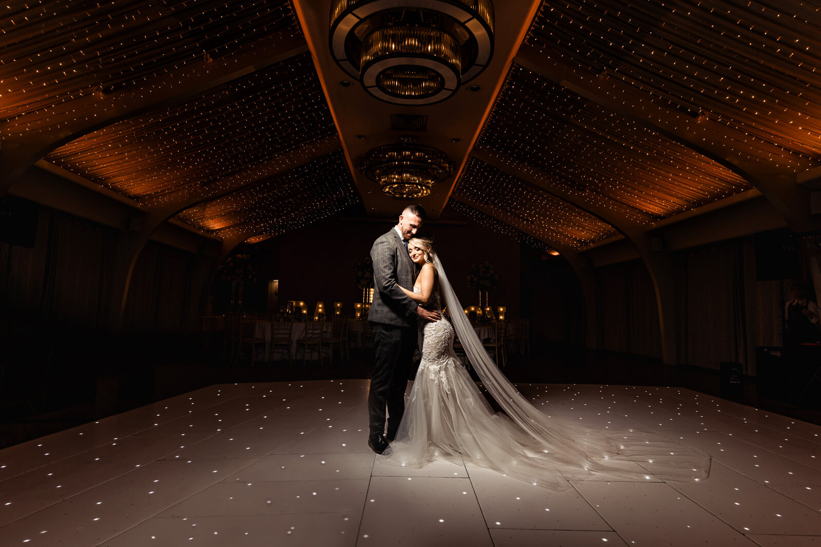 Bride and groom on illuminated dance floor during Elegant Wedding at Colshaw Hall Country Estate with romantic evening lighting