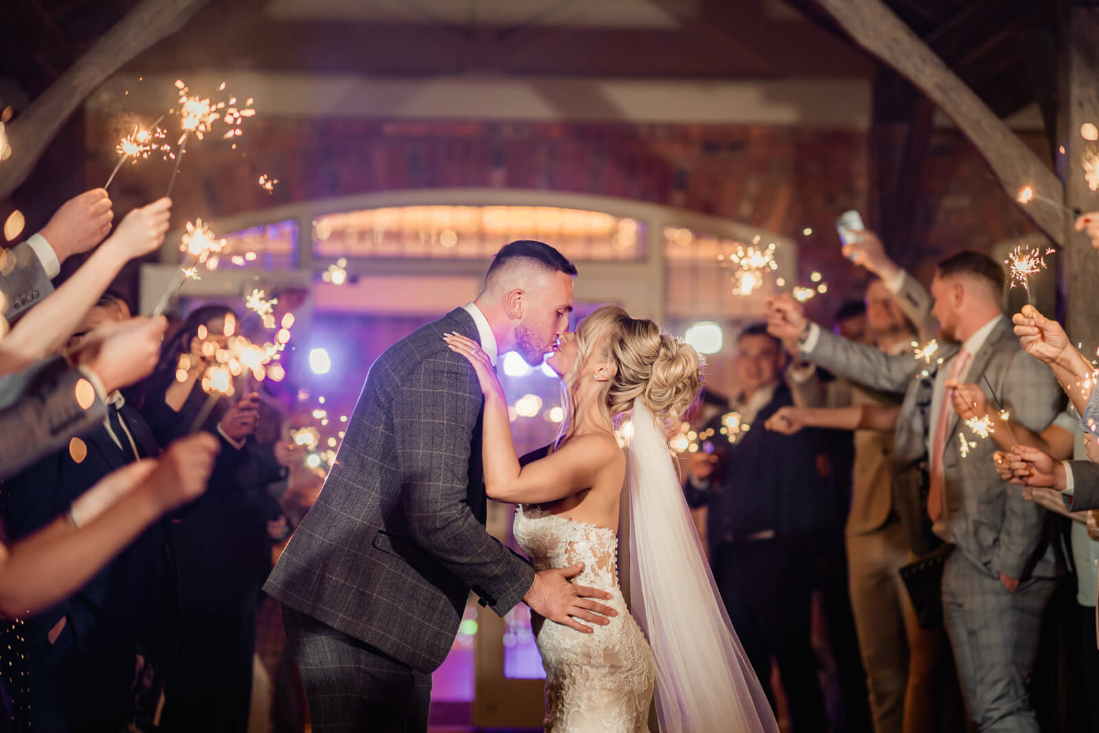 The bride and groom embrace on a glowing dance floor beneath twinkling ceiling lights, creating a romantic evening moment at Colshaw Hall Country Estate.