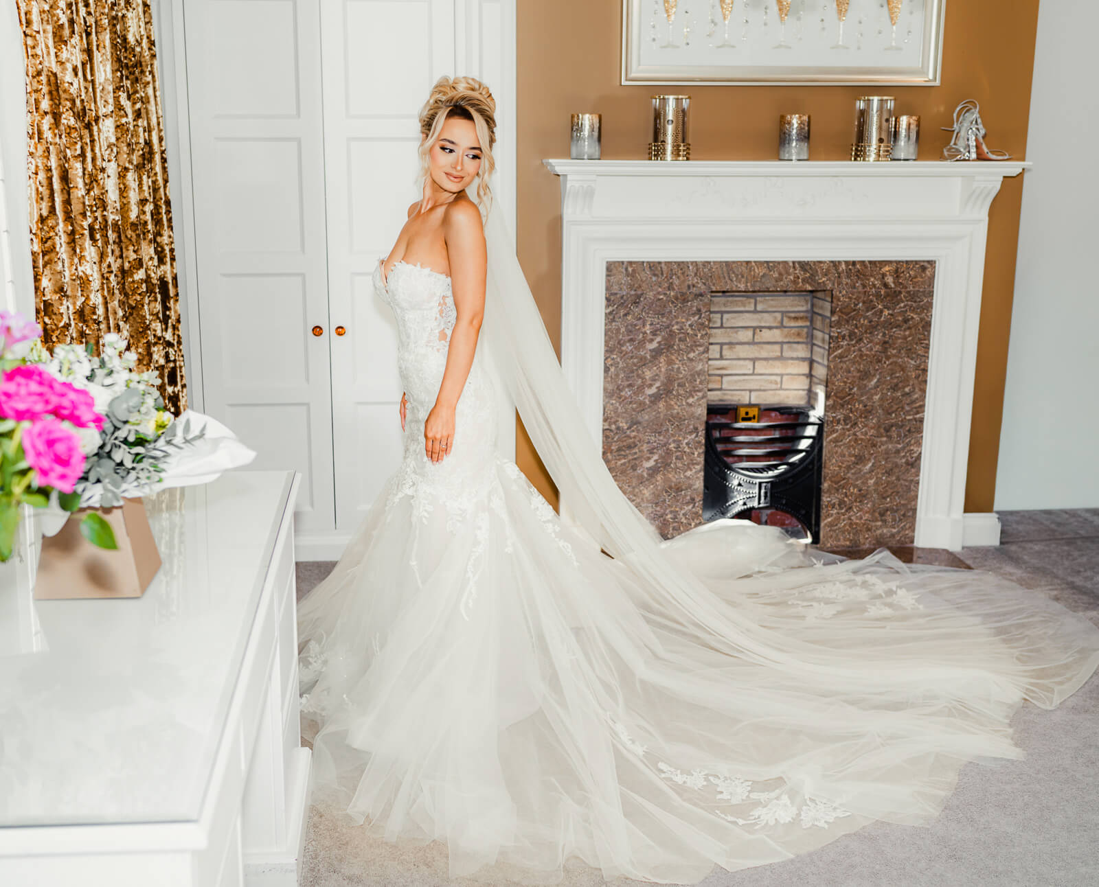 Bride in wedding dress with long veil in bridal suite at Colshaw Hall Country Estate