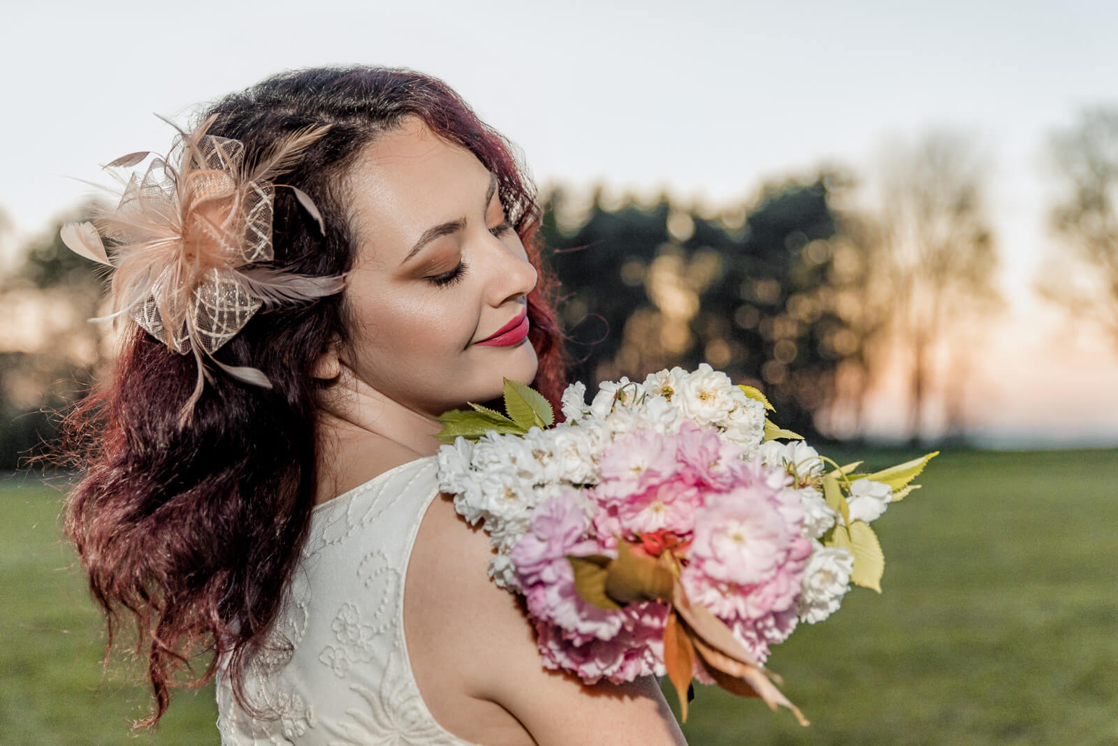 Woman holding cherry blossom bouquet in Harrogate during a spring pre-wedding session