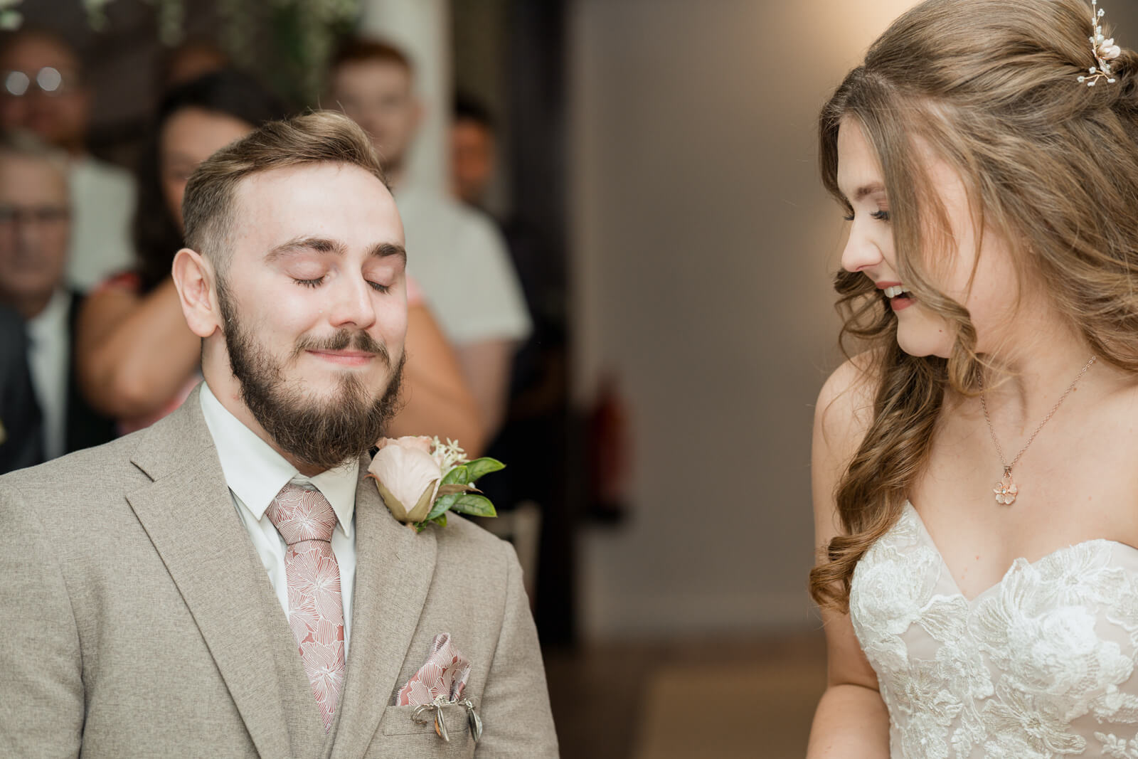 Groom closing his eyes during emotional wedding ceremony moment at Chevin Country Park