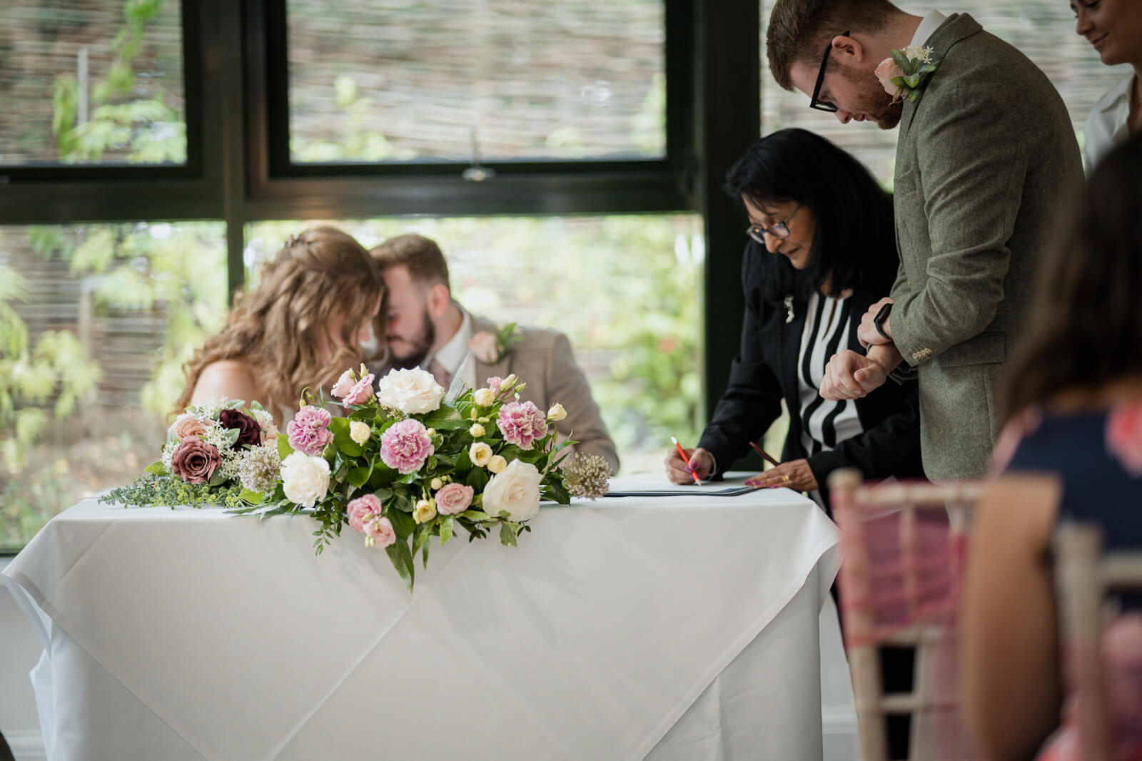 Couple signing the wedding register during ceremony at Chevin Country Park