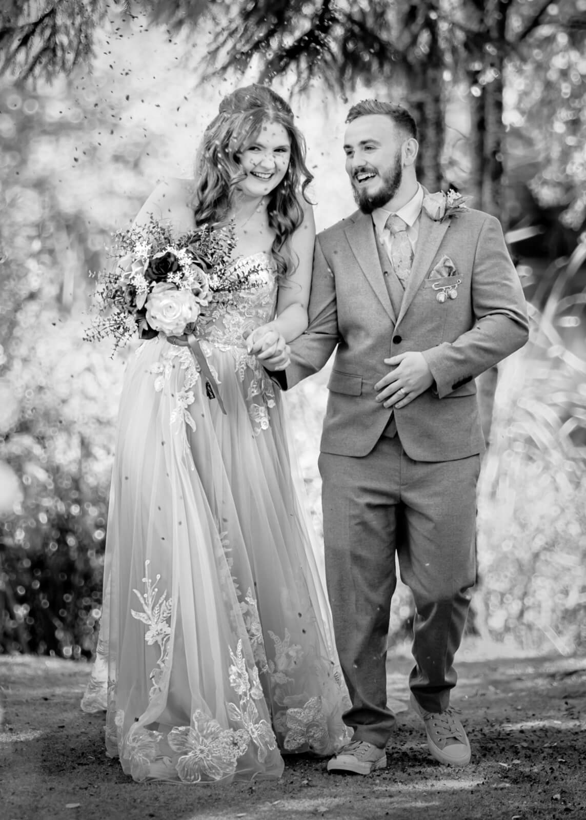 Bride and groom walking together with confetti at Chevin Country Park wedding