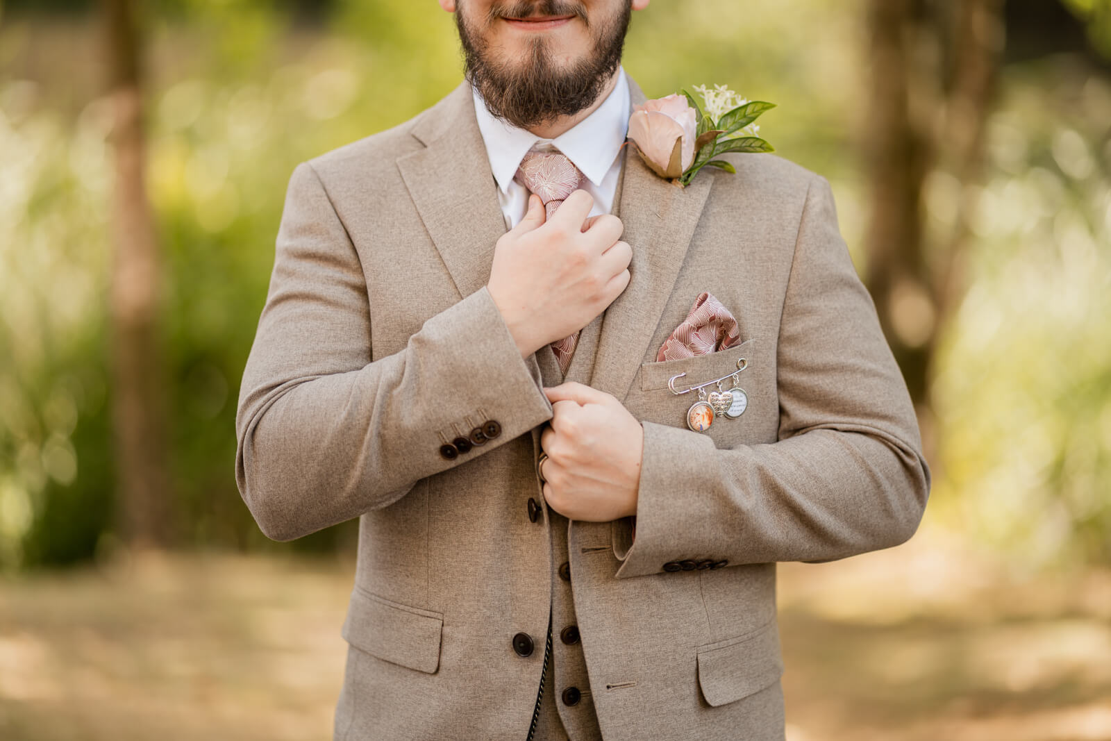 Groom adjusting tie detail at Chevin Country Park wedding