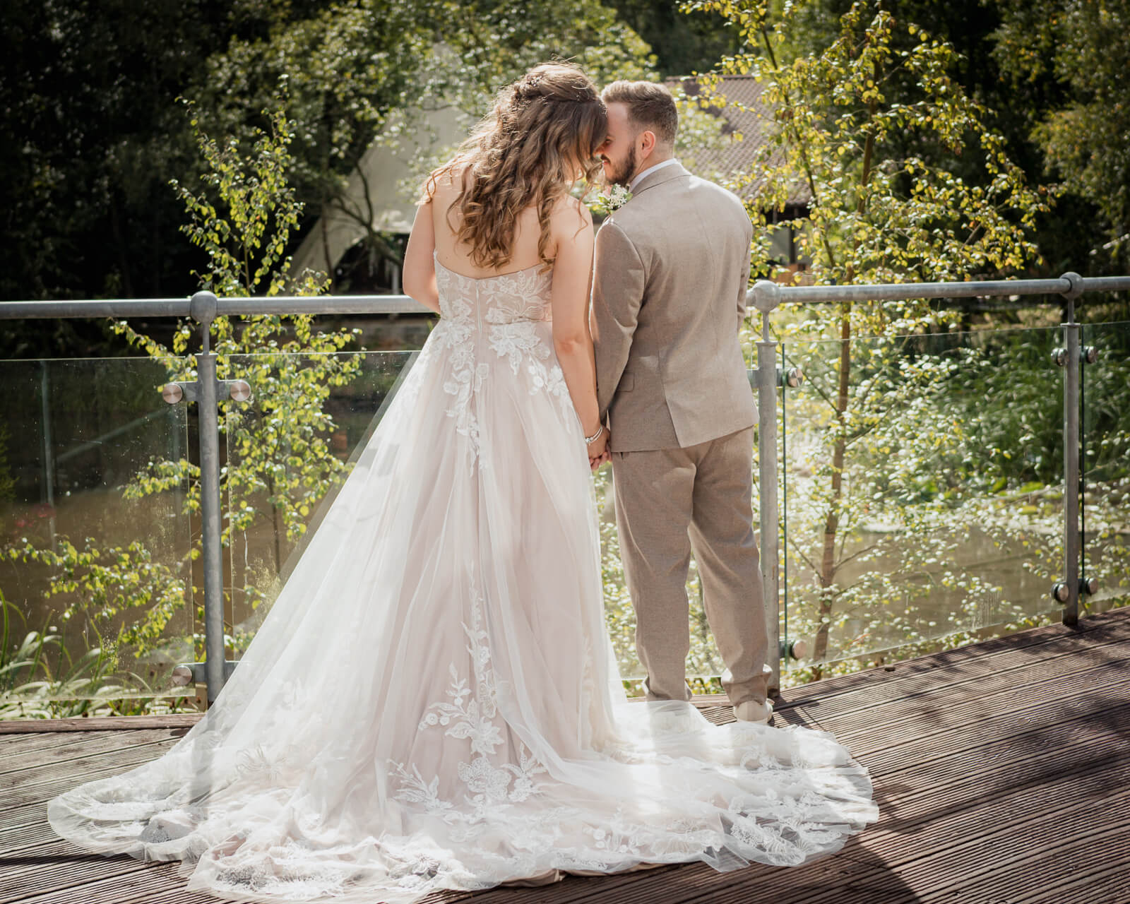 Bride and groom standing on a wooden deck at Chevin Country Park