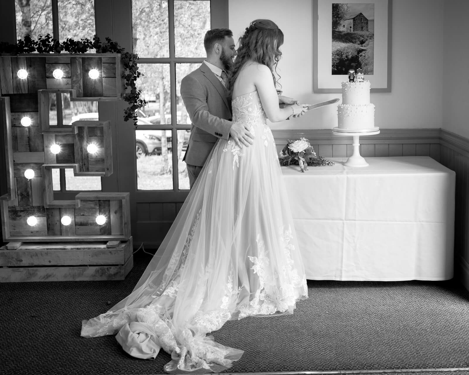 Bride and groom cutting wedding cake at Chevin Country Park