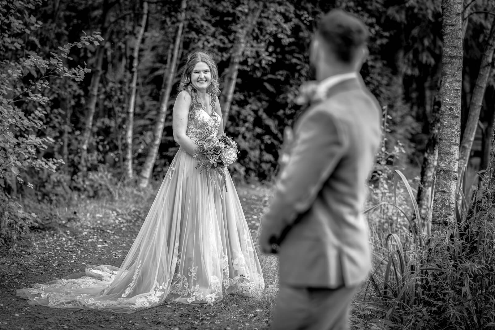 Bride and groom sharing a moment in woodland at Chevin Country Park wedding