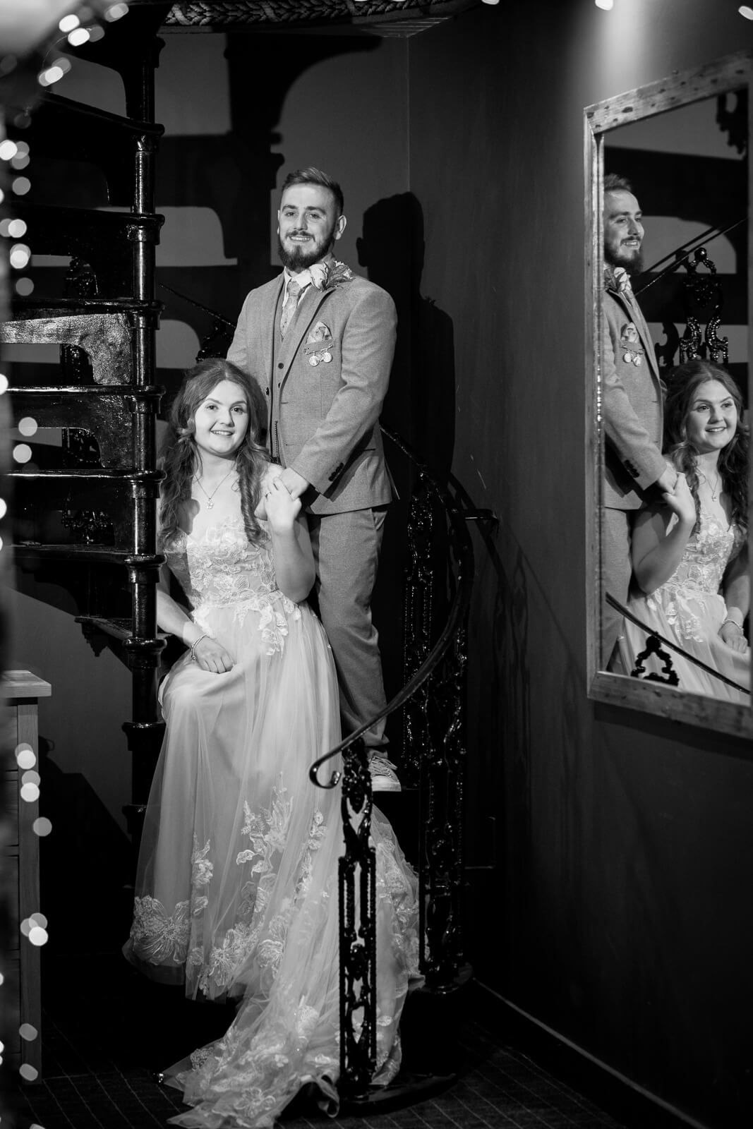 Black and white portrait of bride and groom on spiral staircase at Chevin Country Park