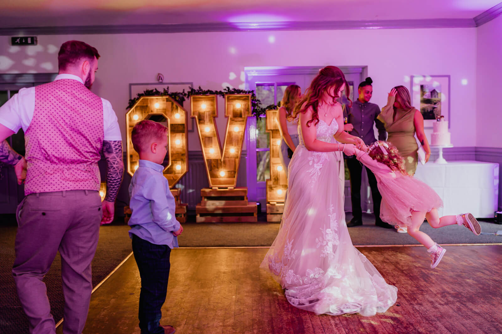 Bride spinning flower girl on dance floor at Chevin Country Park wedding reception