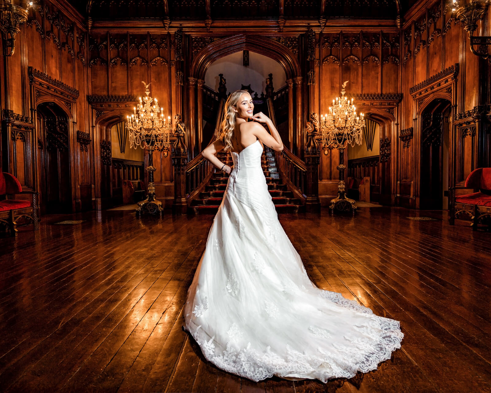 bridal portrait in grand hall with chandelier lighting and elegant interior