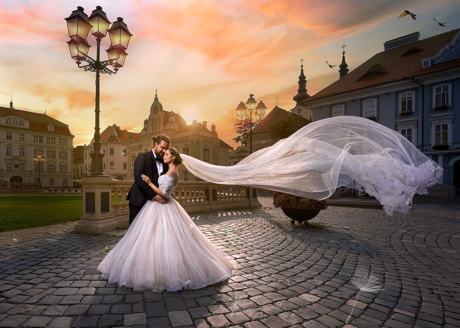 editorial wedding portrait with flowing veil at sunset in a historic square