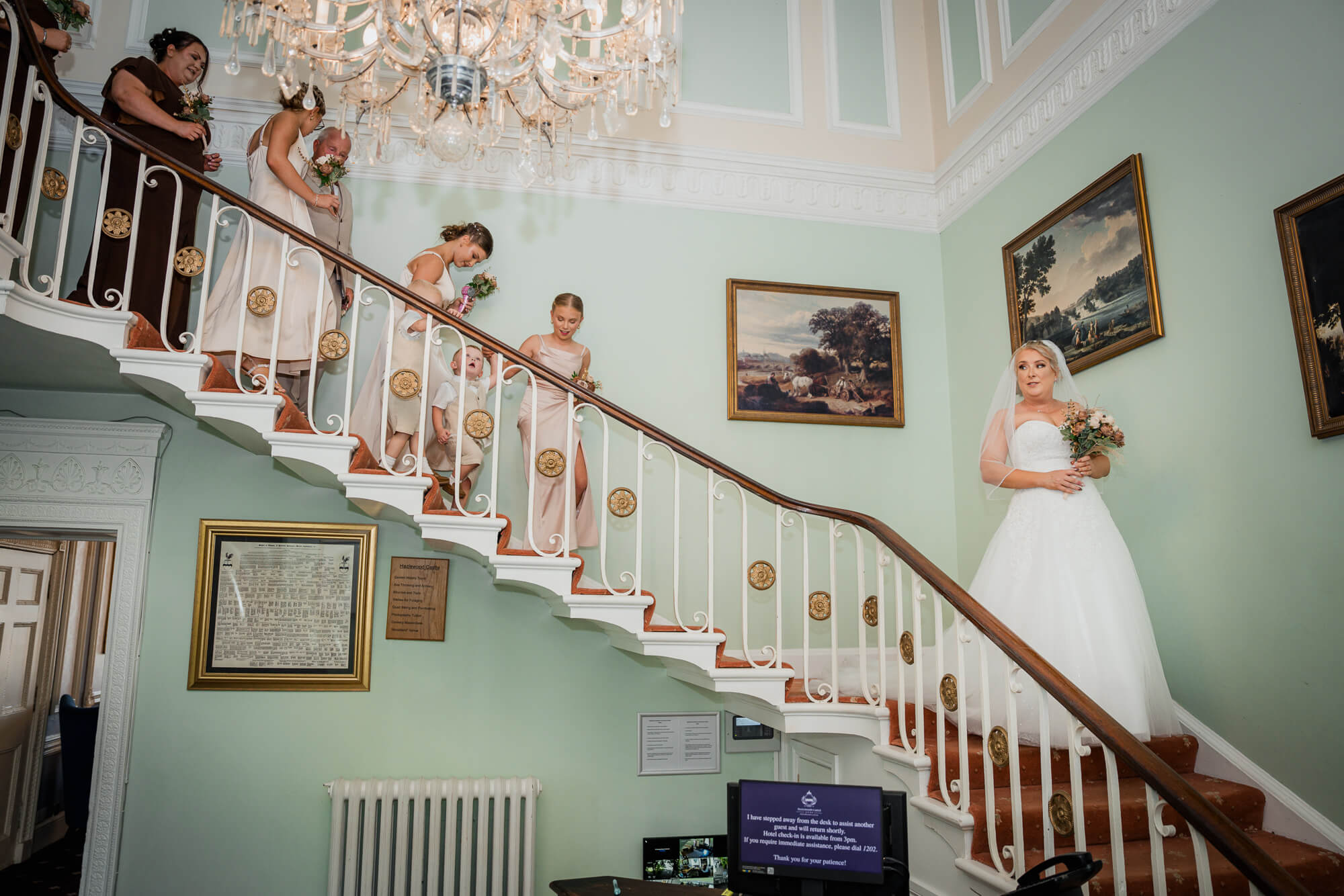 Bride descending the grand staircase at Hazlewood Castle.