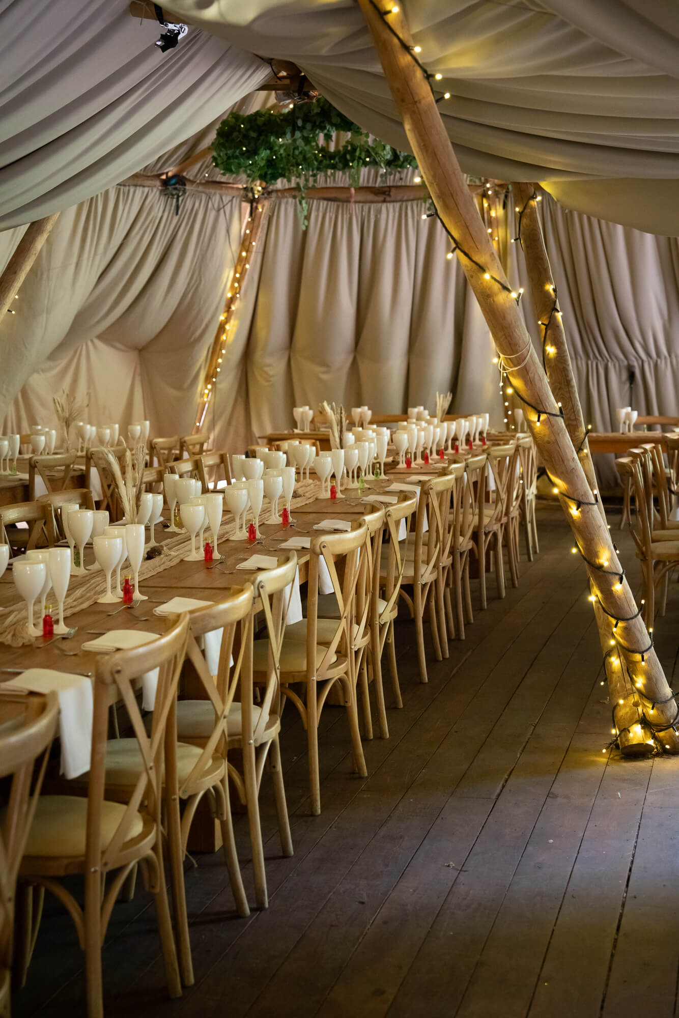 Woodland wedding reception tipi prepared for guests at Hazlewood Castle.