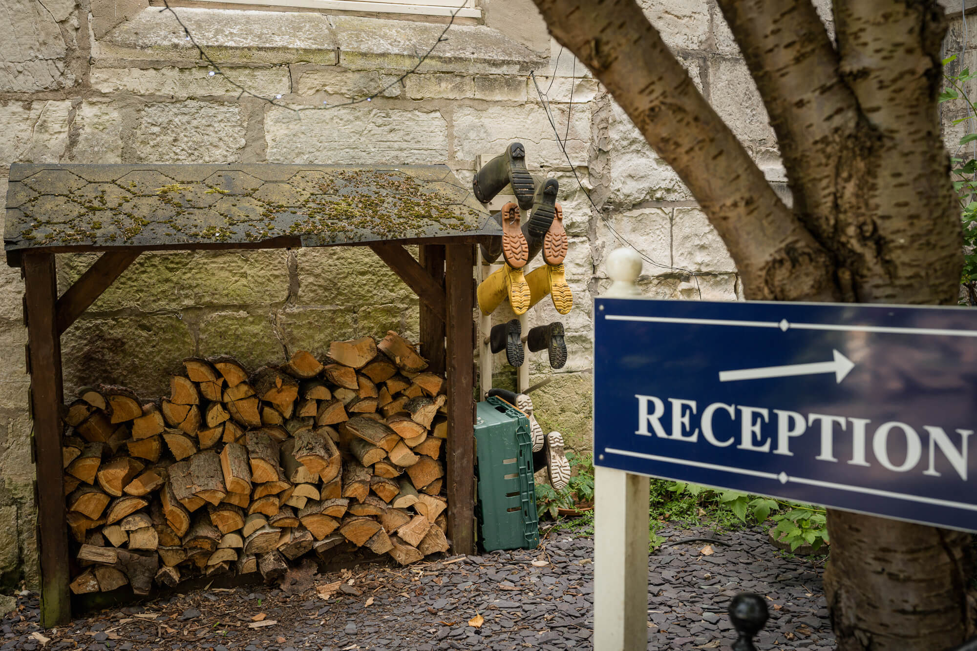 Wellington boots drying beside the reception sign at Hazlewood Castle.