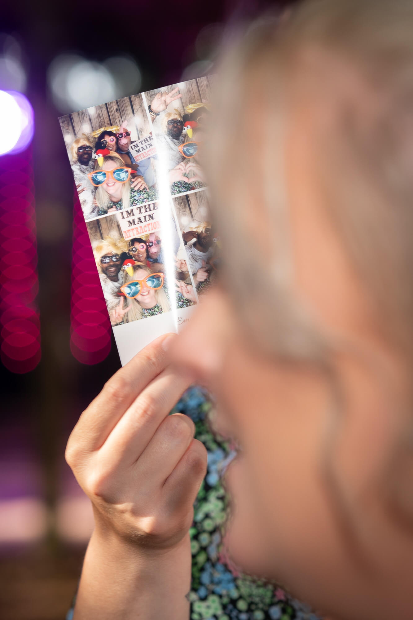 Wedding guest holding a photobooth print at Hazlewood Castle evening reception.