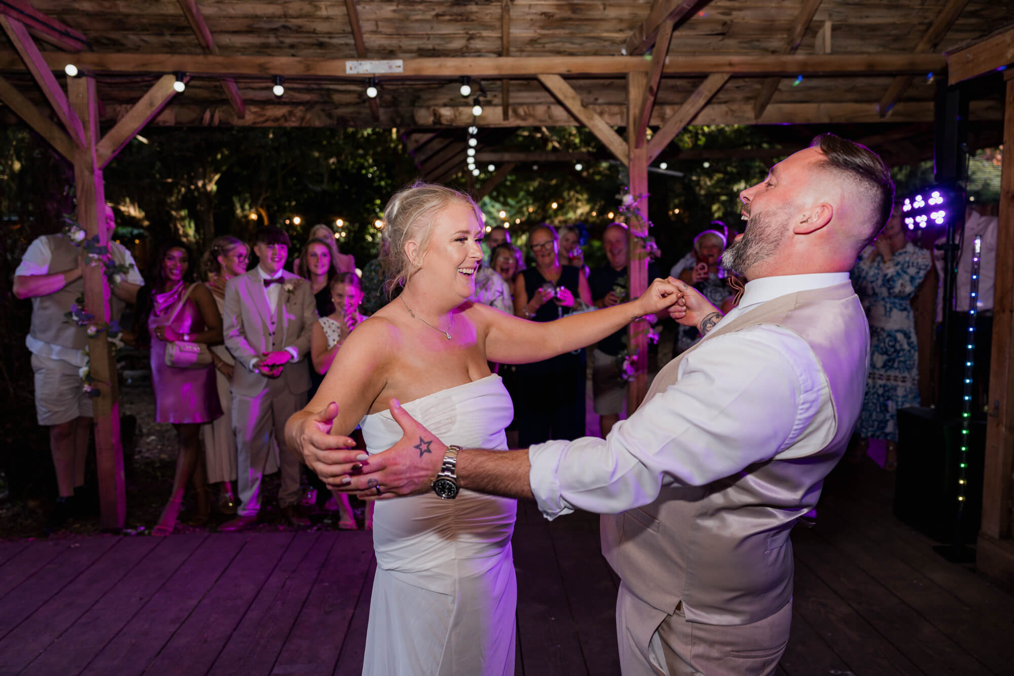 Bride and groom laughing during their first dance at Hazlewood Castle.