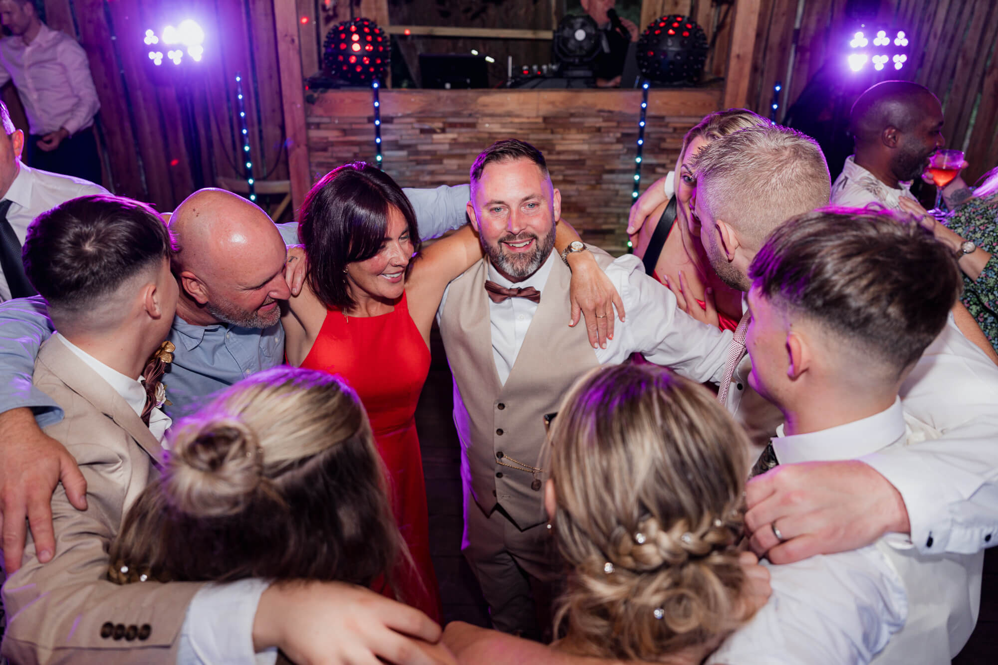 Groom celebrating with guests on the dance floor at Hazlewood Castle wedding reception.