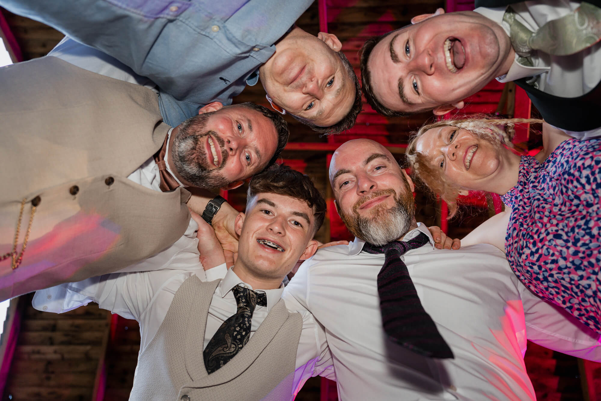 Group portrait of wedding guests on the dance floor at Hazlewood Castle.