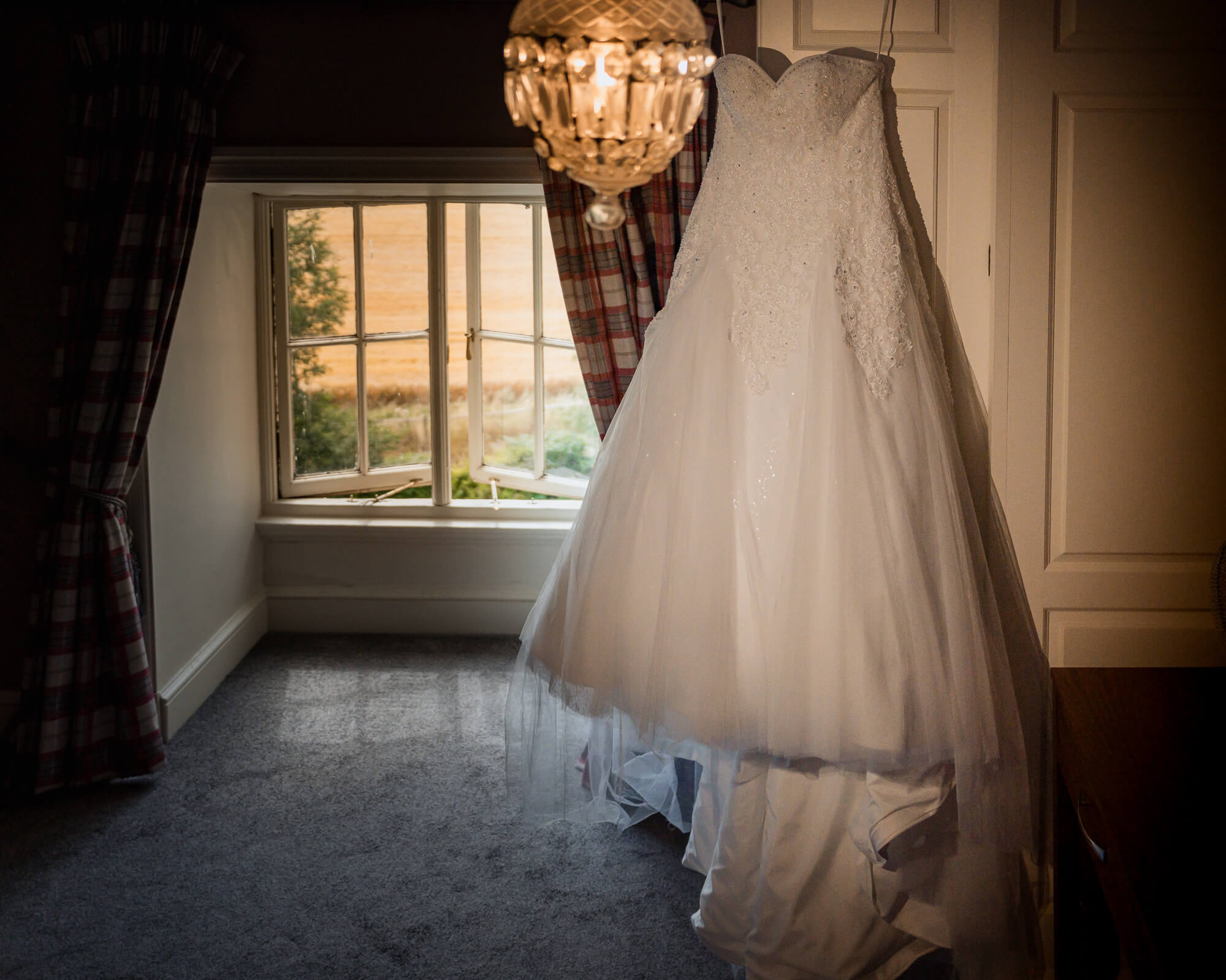 Bridal wedding dress hanging in the bridal suite at Hazlewood Castle.