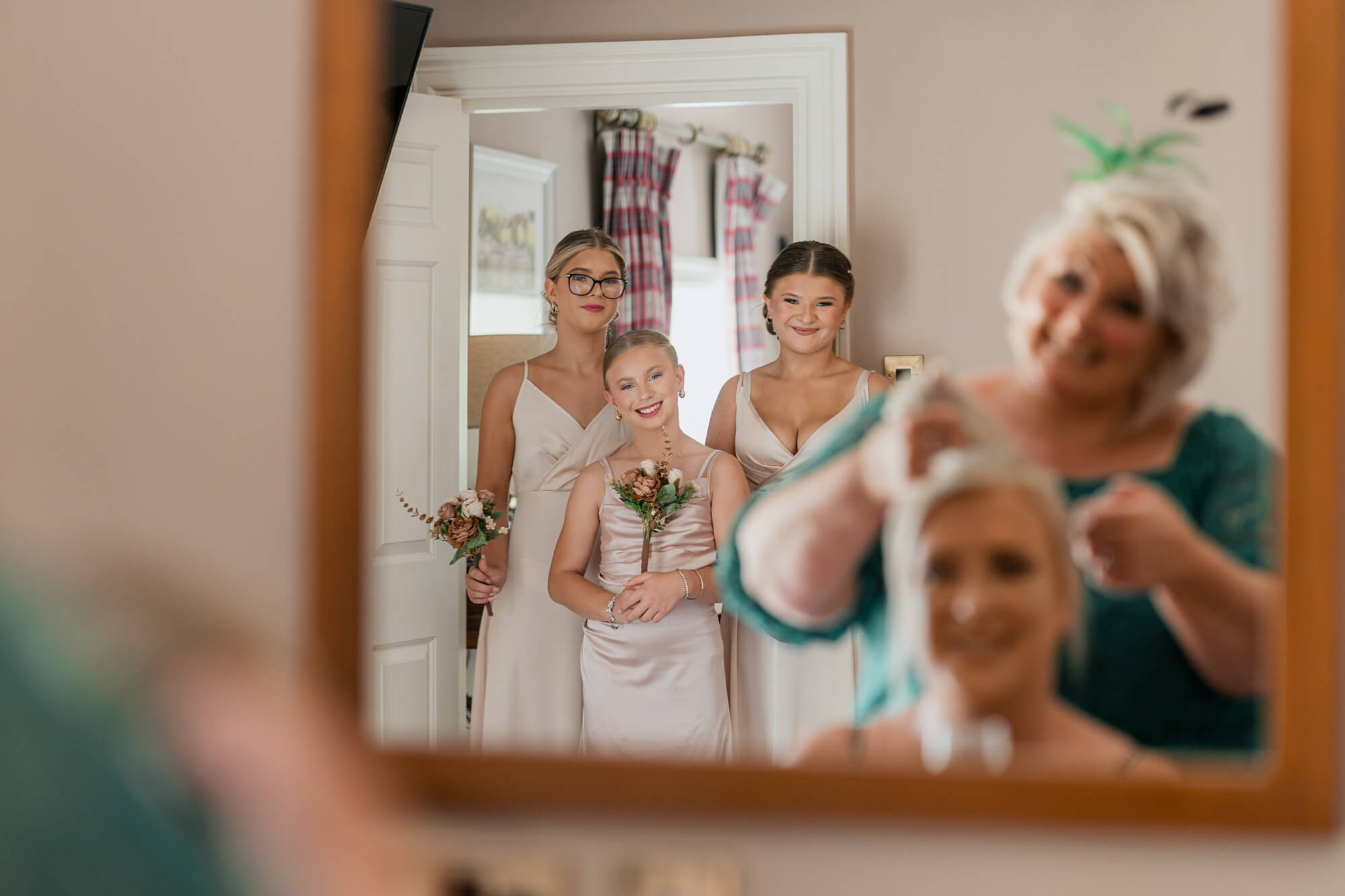 Bridesmaids watching the bride's mother during bridal preparations.