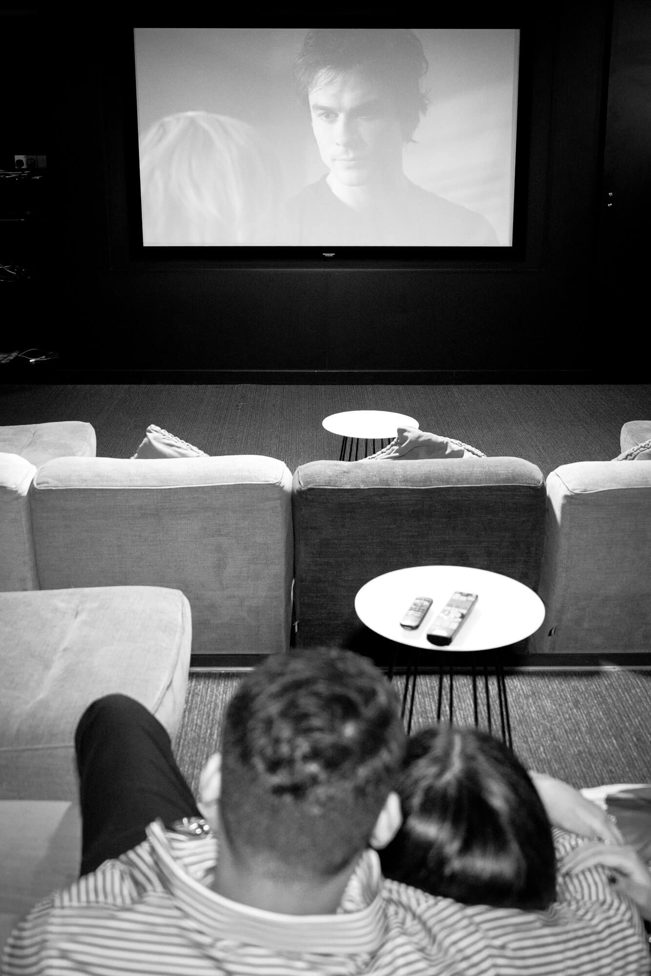 Indian Couple relaxing during a film in the cinema room Iconic Leeds.