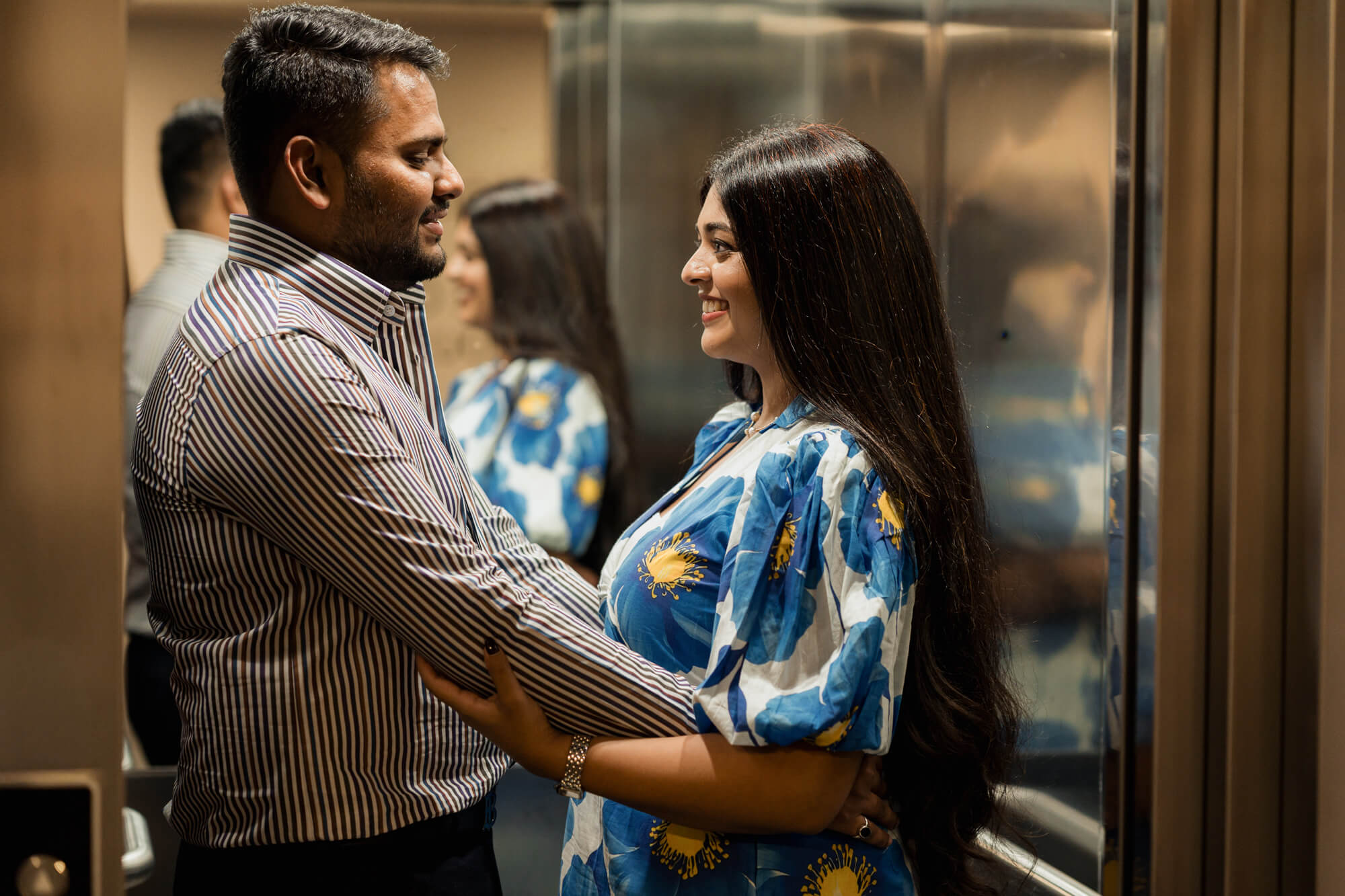 Romantic portrait of an engaged couple embracing inside a lift during a Leeds pre-wedding photoshoot.